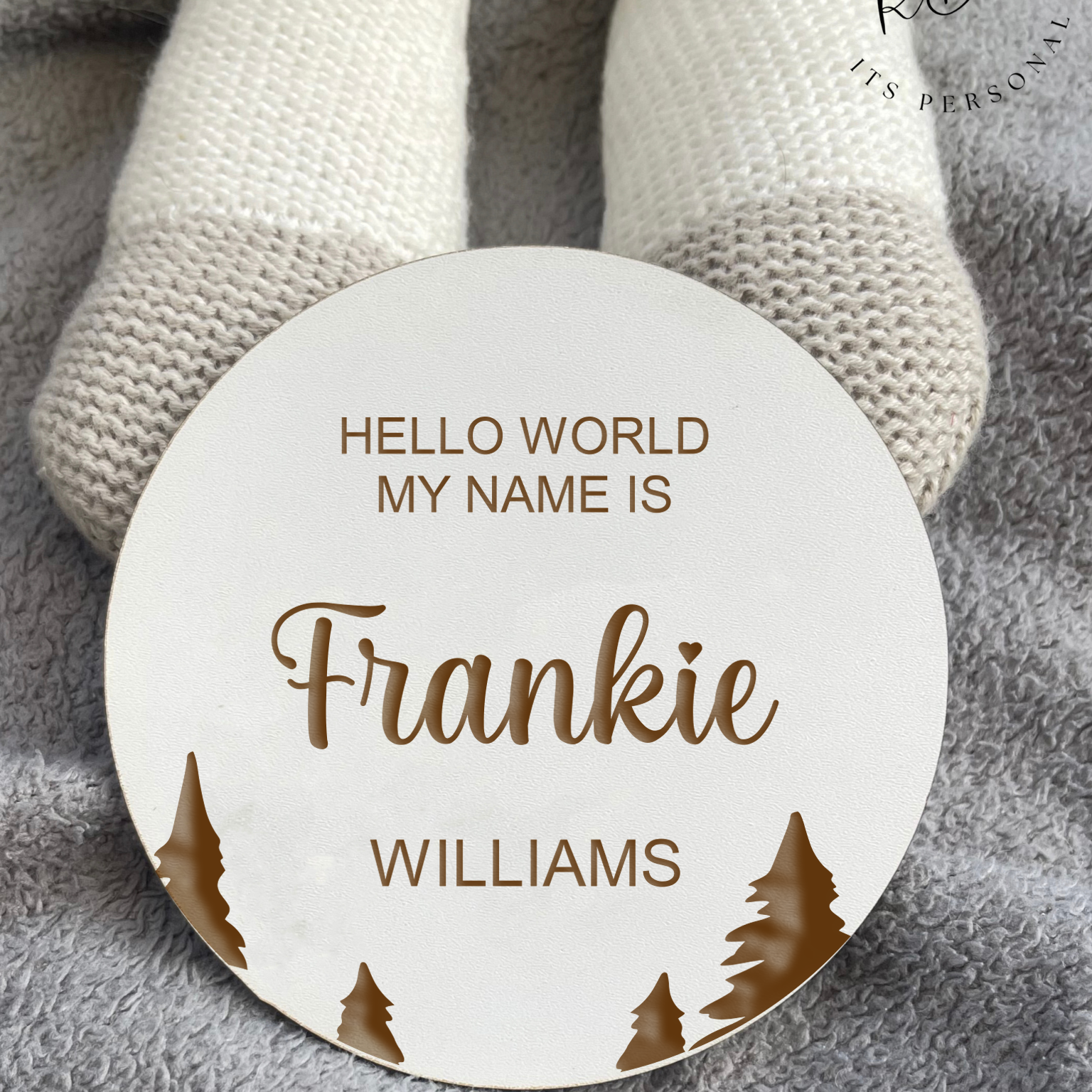 A personalised baby announcement sign with a serene tree design, stylishly displayed in a cosy nursery, highlighting the baby's name and birth details in refined lettering.
