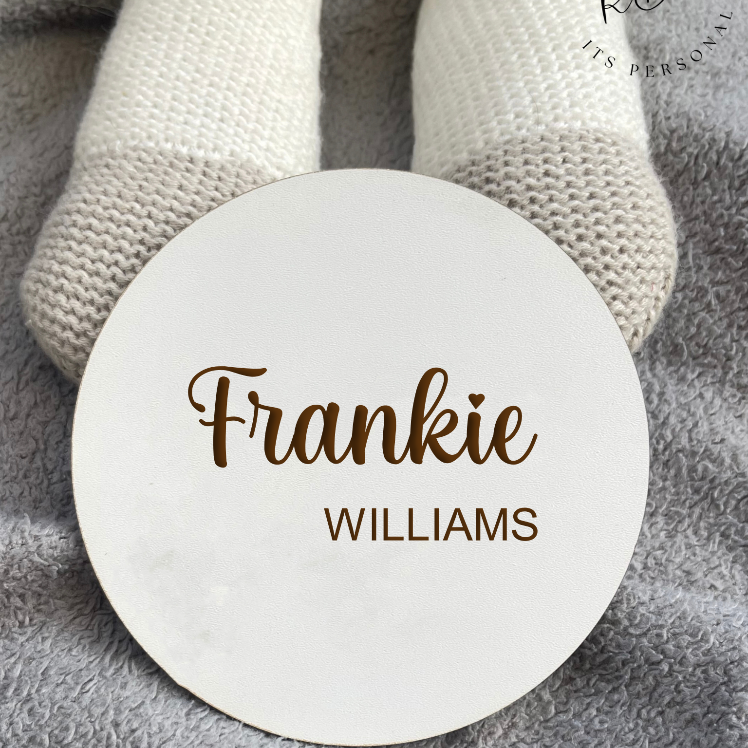 Custom white MDF round baby plaque with a delicate design, showcasing the baby's full name and crafted as a memorable keepsake, ideal for gifting or personal use.