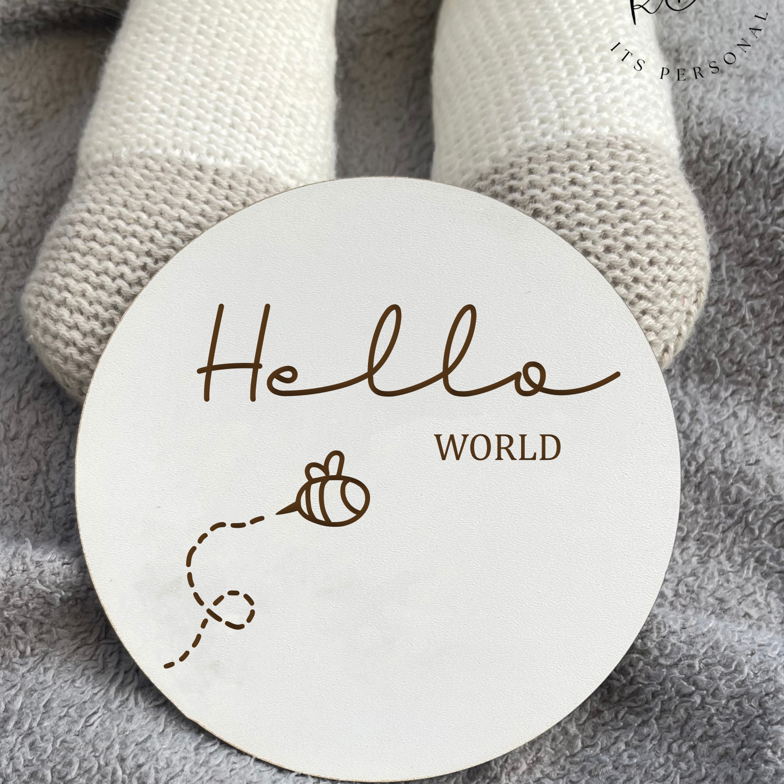 White MDF 'Hello World' baby announcement plaque with a detailed bee design, ideal for introducing your baby in style.