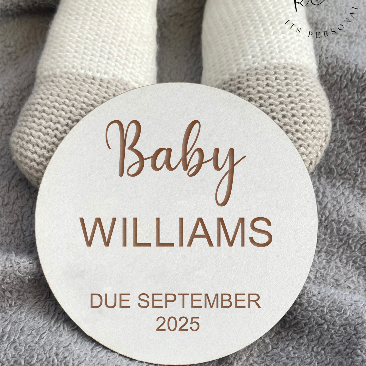 Close-up of engraved baby name and due date on wooden plaque