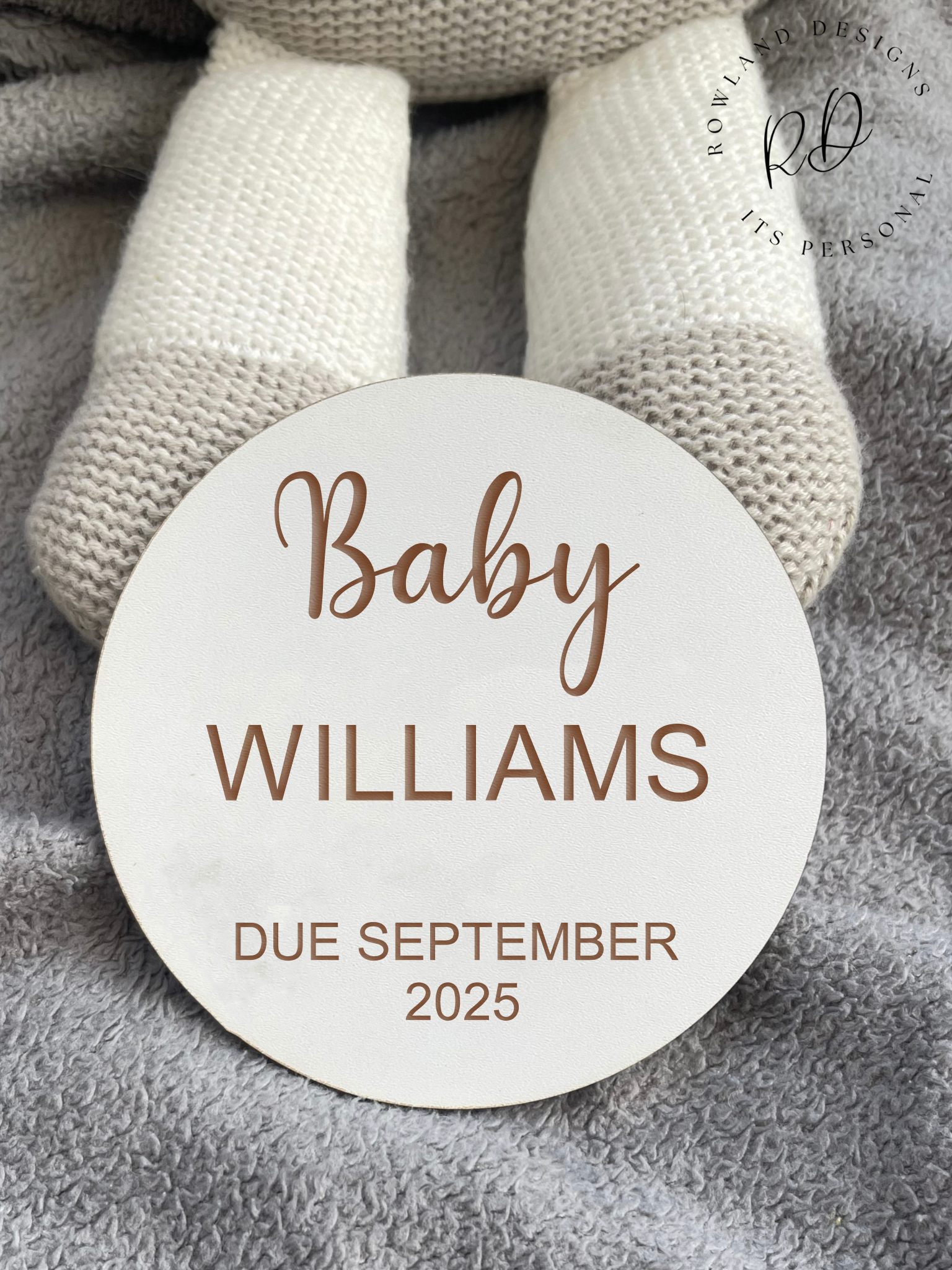 Flat lay of baby announcement sign with baby accessories
