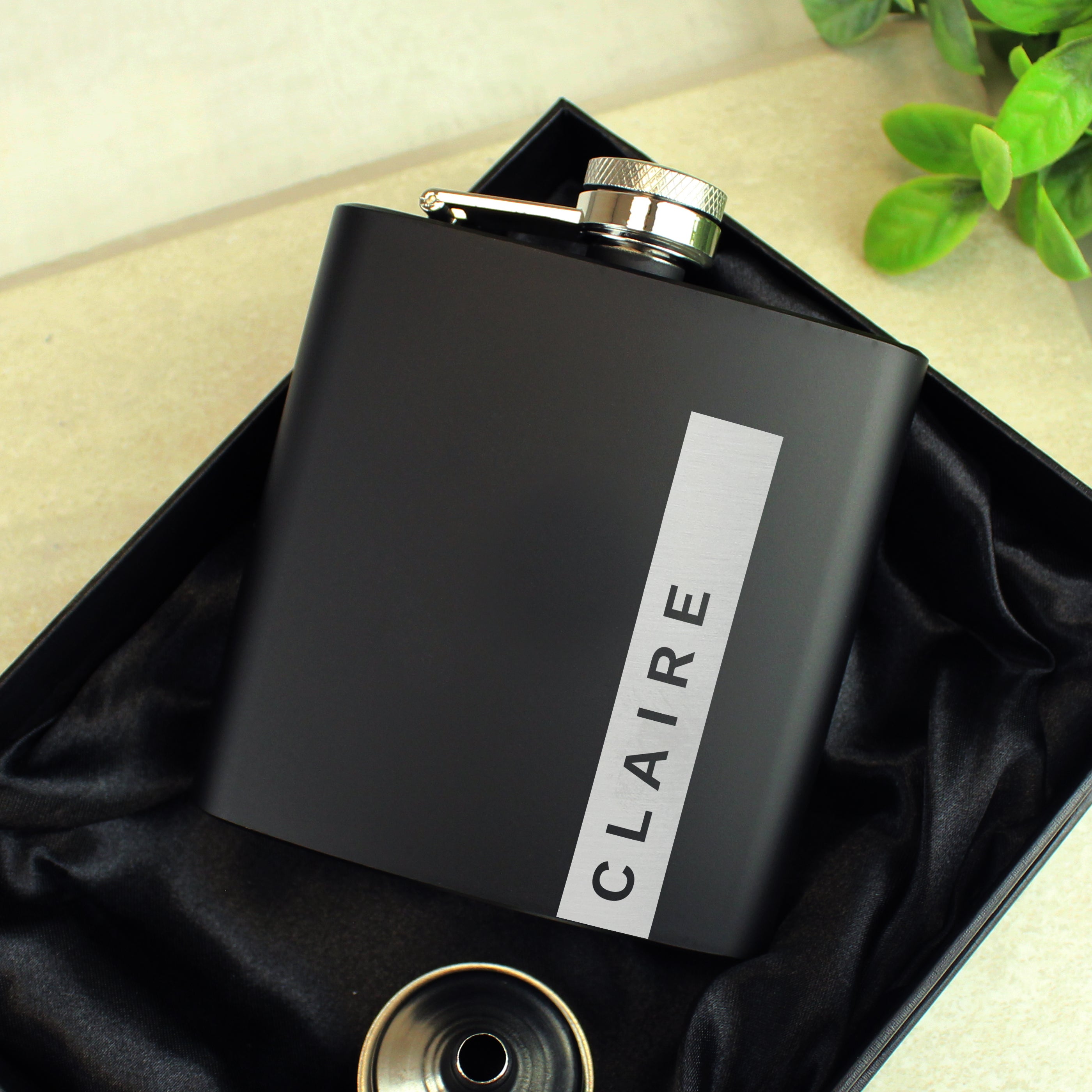 Personalised black hip flask in a luxurious silk-lined presentation box.