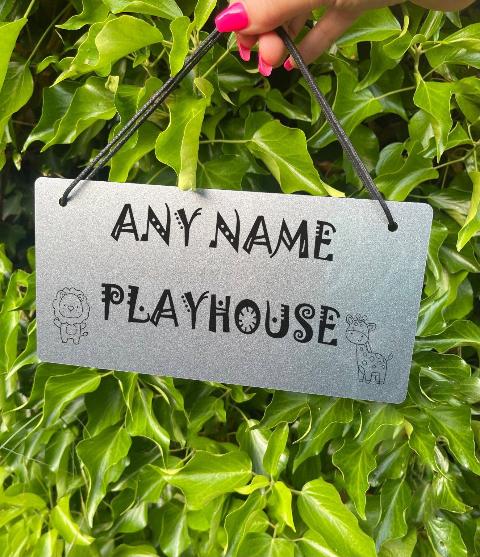 A personalised kids playroom sign showing a custom name, along with the cute lion and giraffe design