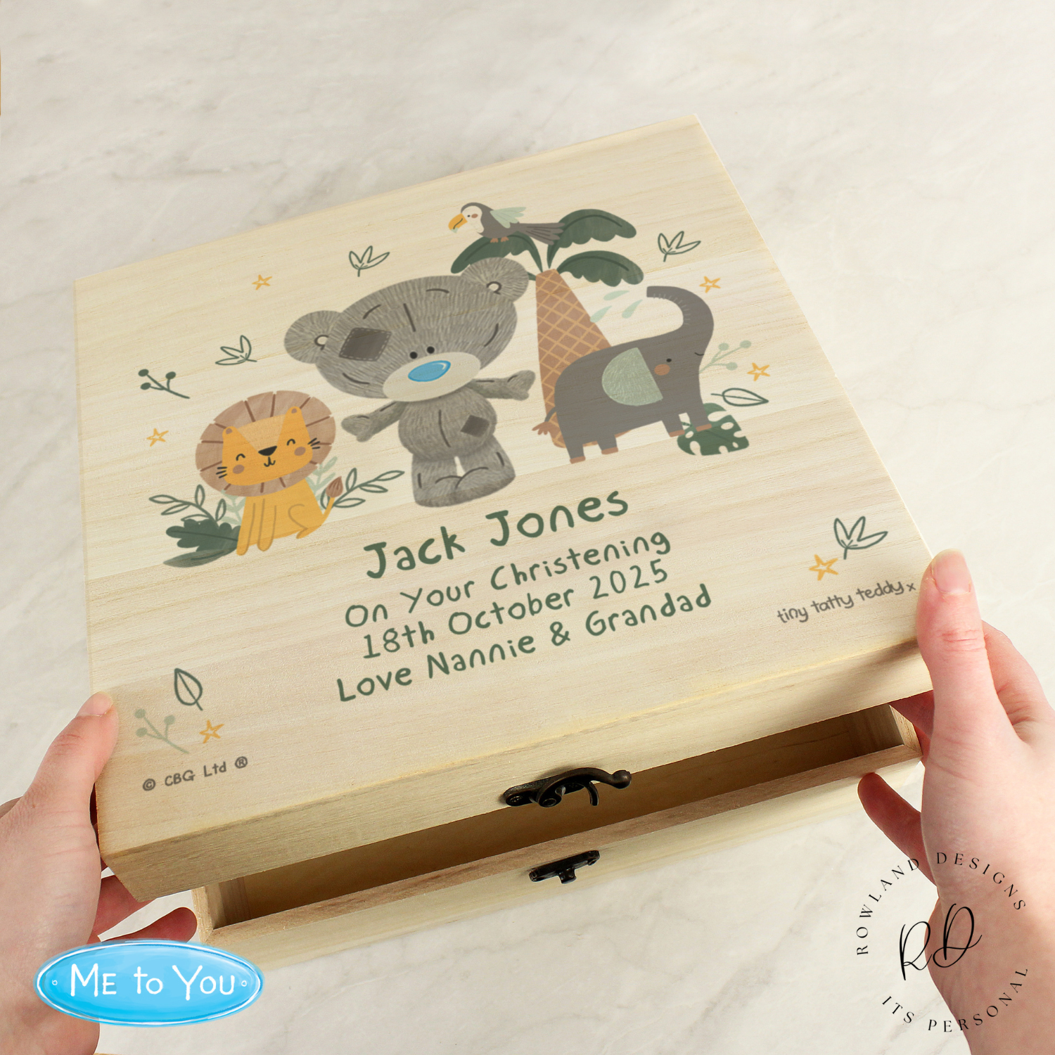 Text: Baby gift keepsake box placed in nursery setting