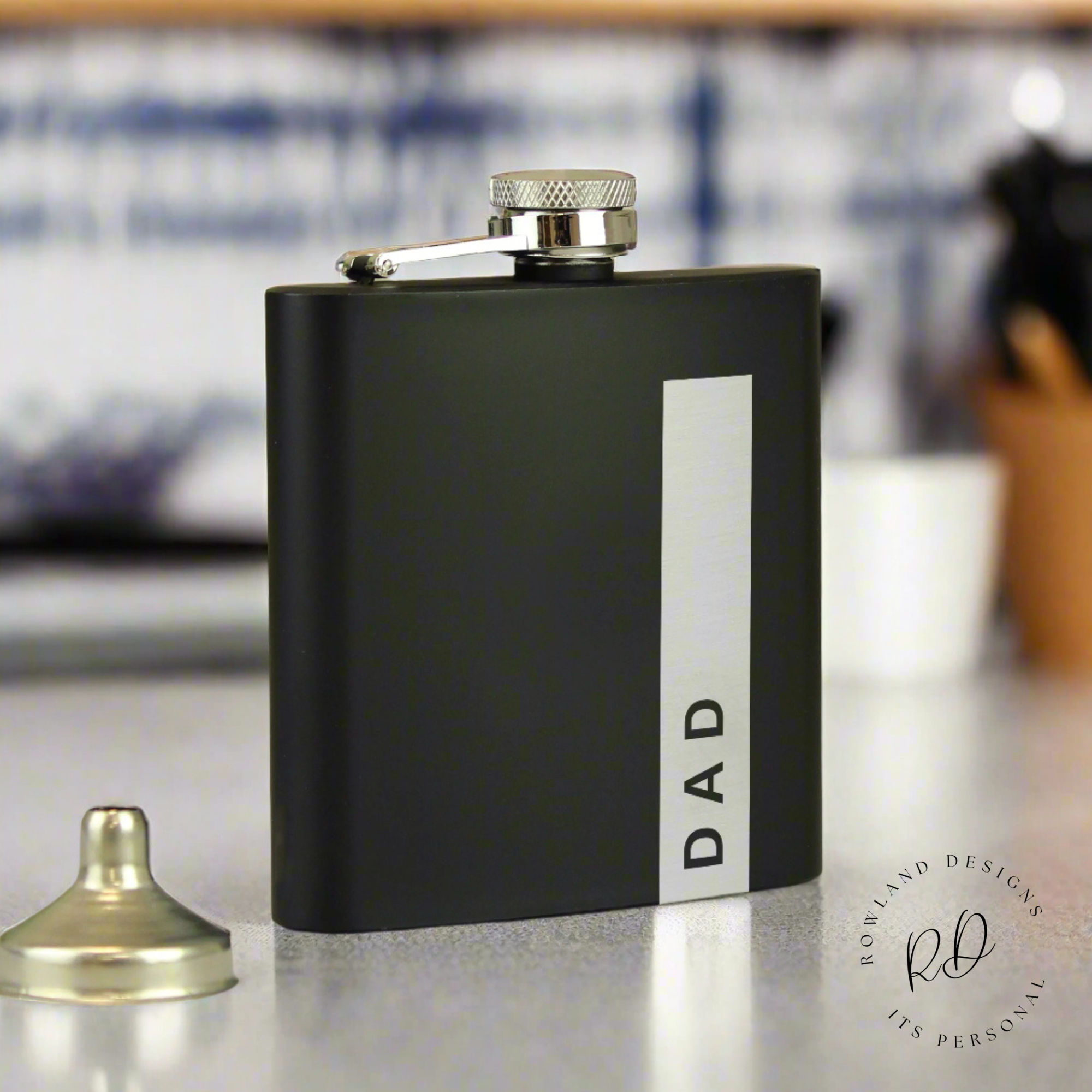 Personalised black stainless steel hip flask with custom name engraving.