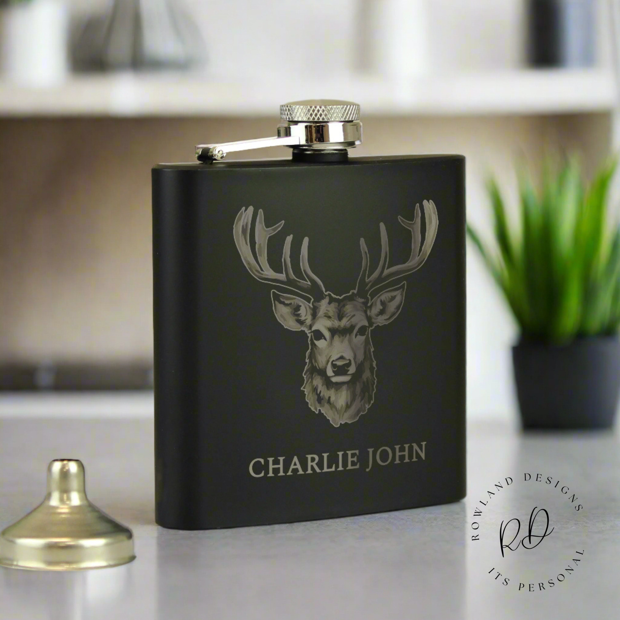 Elegant black stainless steel hip flask with custom engraving.