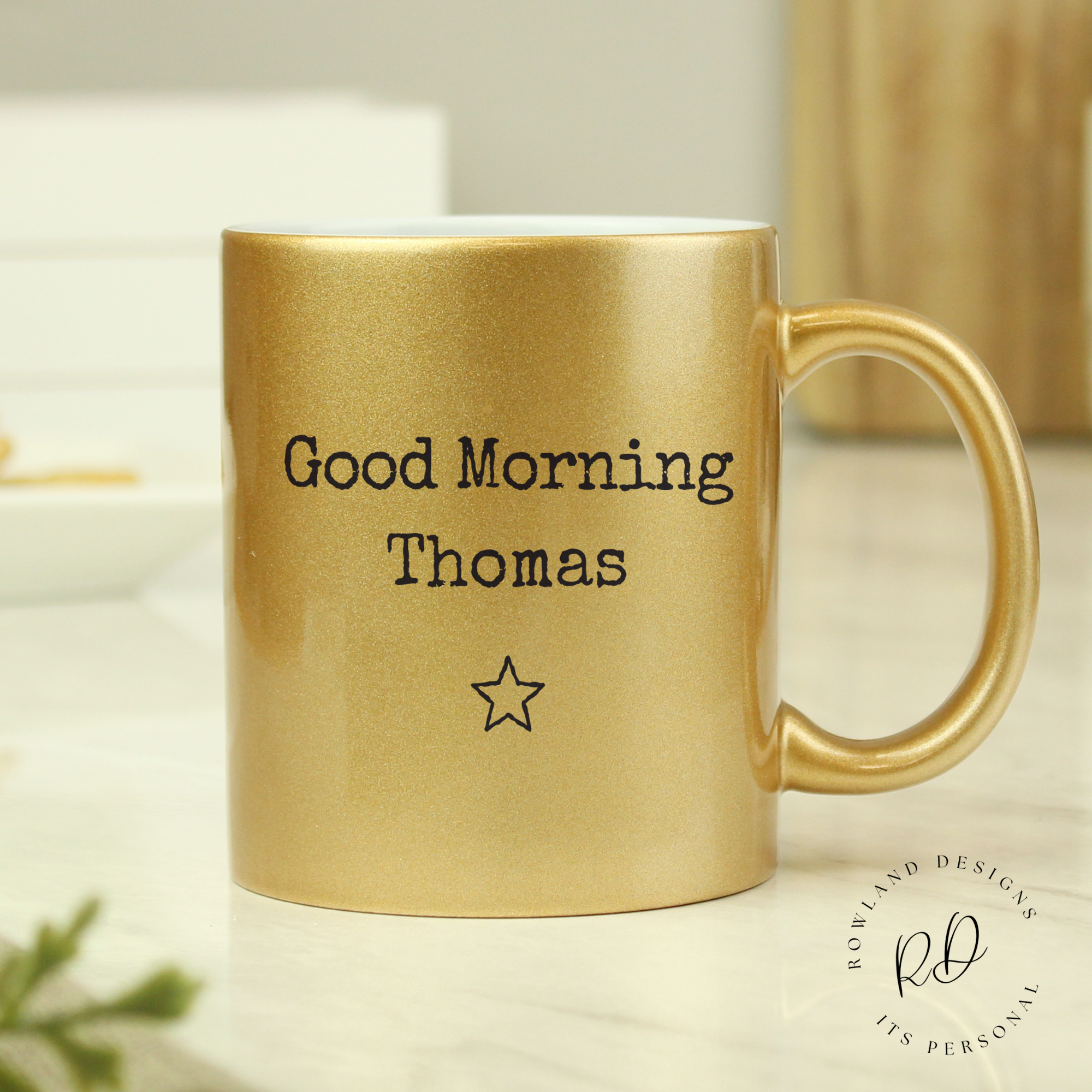 Close-up view of the personalisation on the gold mug.