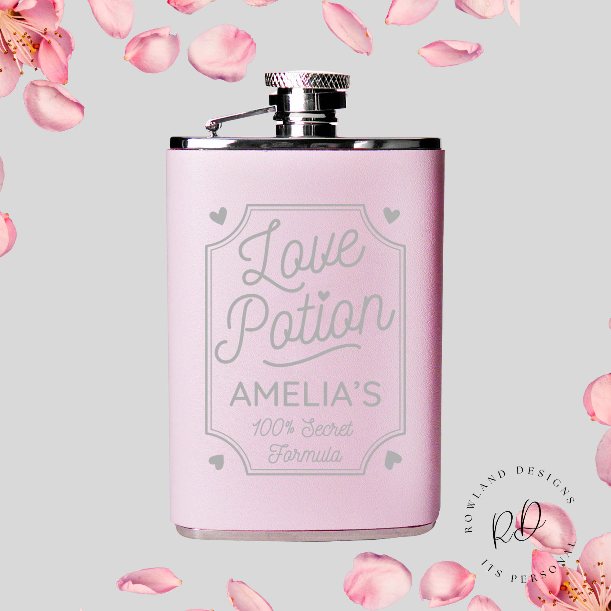 Engraved pink hip flask with "Love Potion" text.