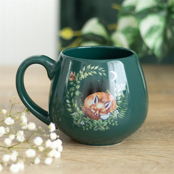 Green ceramic mug with sleeping fox design