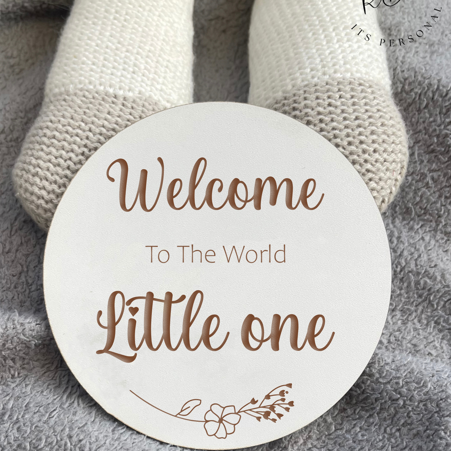 Personalised baby name announcement plaque in clean white MDF with engraved floral details.
