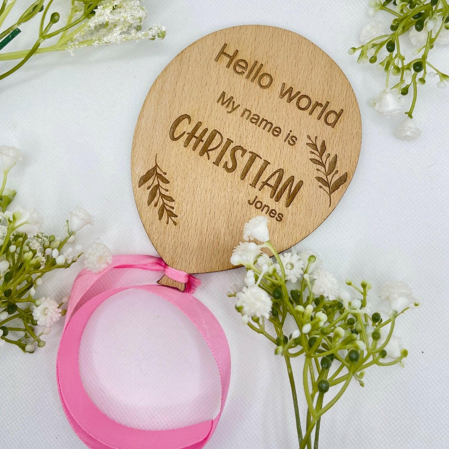 Handcrafted baby announcement plaque in a balloon shape with an elegant pink ribbon