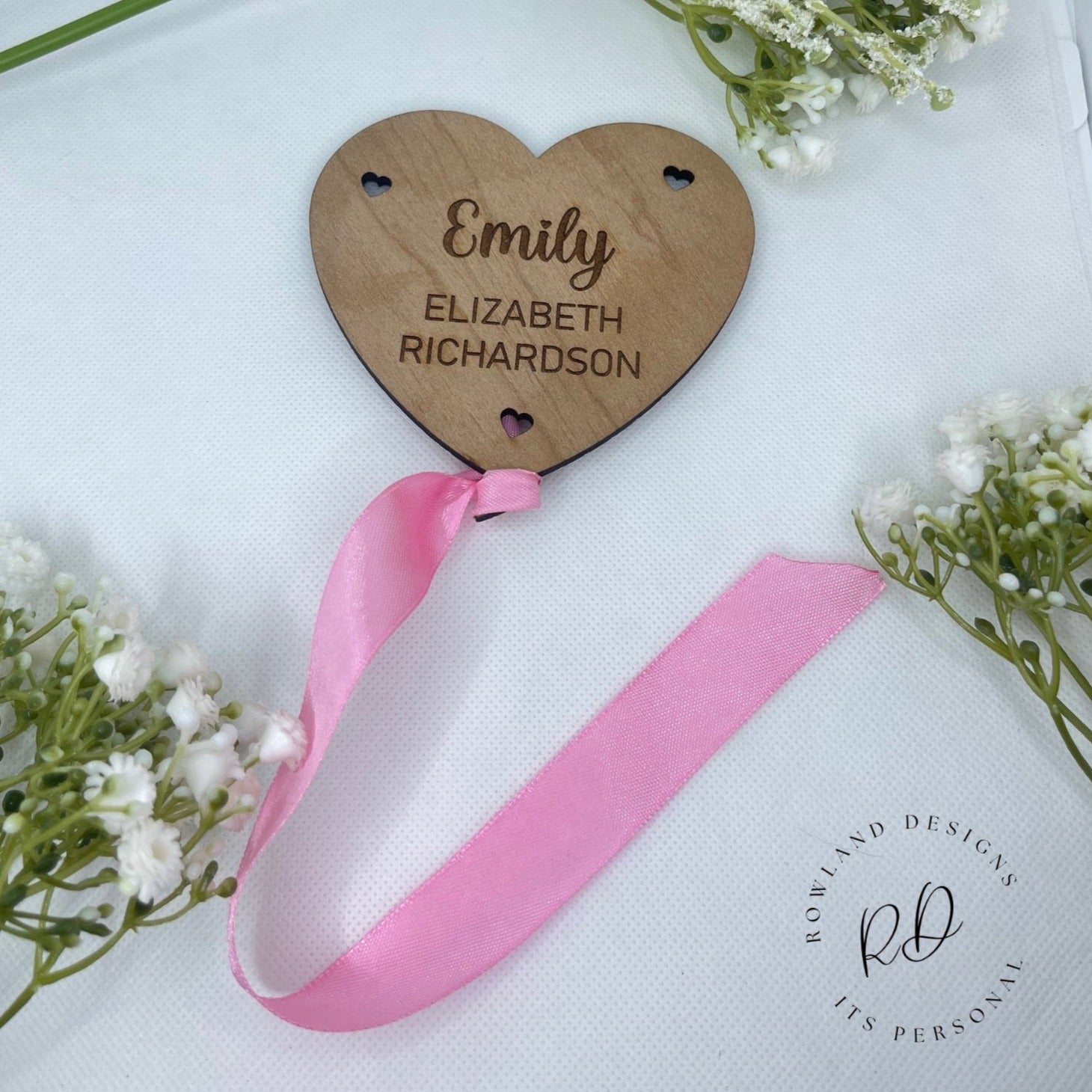 A flat-lay photo showing the personalised balloon and heart plaque .