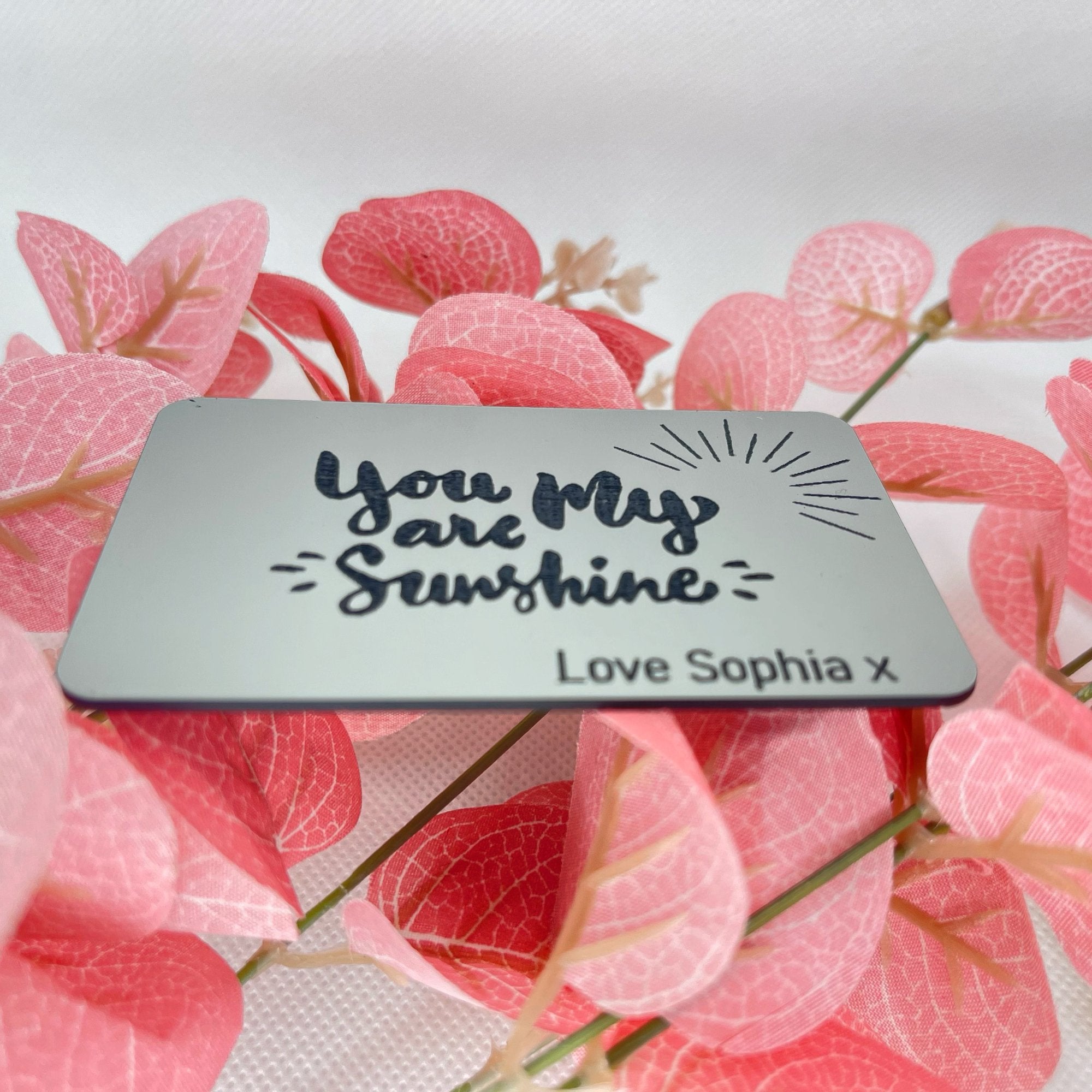 Close-up of the engraved "You Are My Sunshine" message and custom name on a wallet card insert.