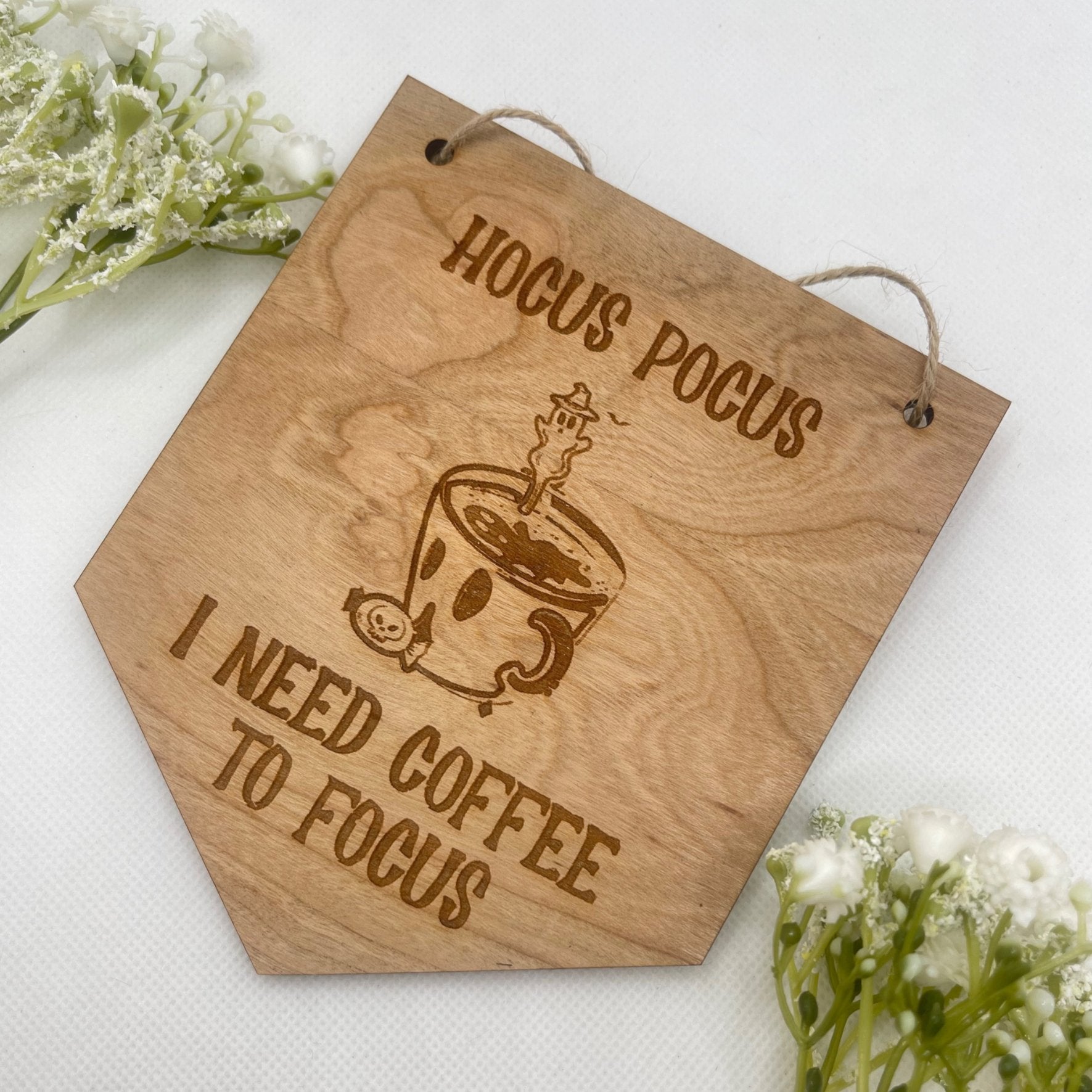 A coffee lover's Halloween gift, showing the humorous "Hocus Pocus I Need Coffee" sign.