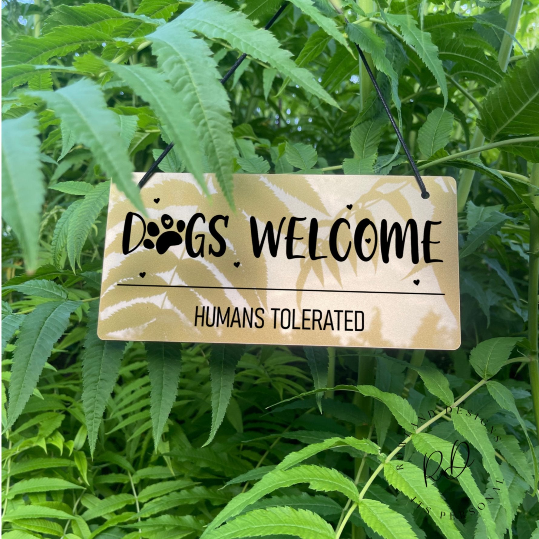 Gold acrylic sign with Dogs Welcome, Humans Tolerated text