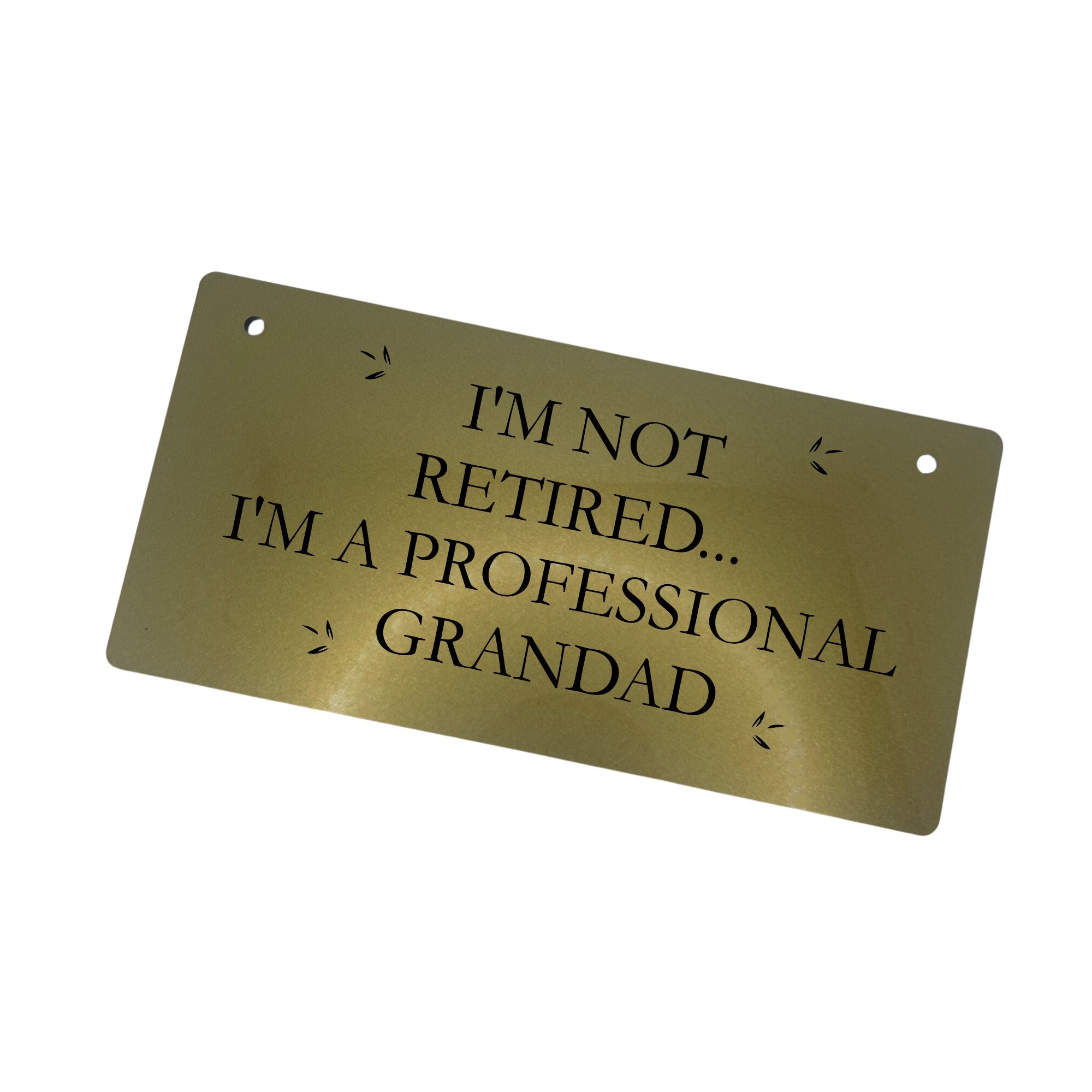 A gold-finished "Professional Grandad" sign, showing the engraved text and its sleek design.