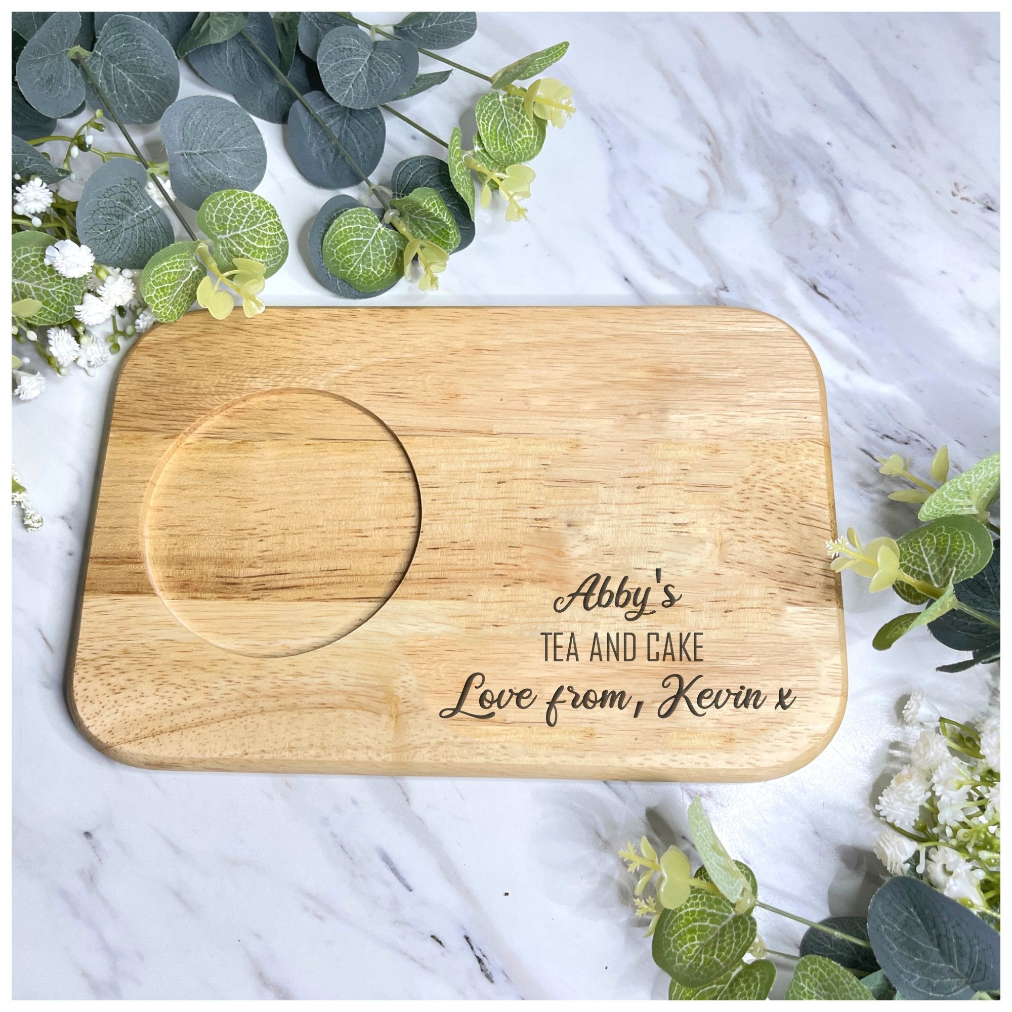 Engraved wooden tea and biscuit board shown with tea cup and treats, perfect for her