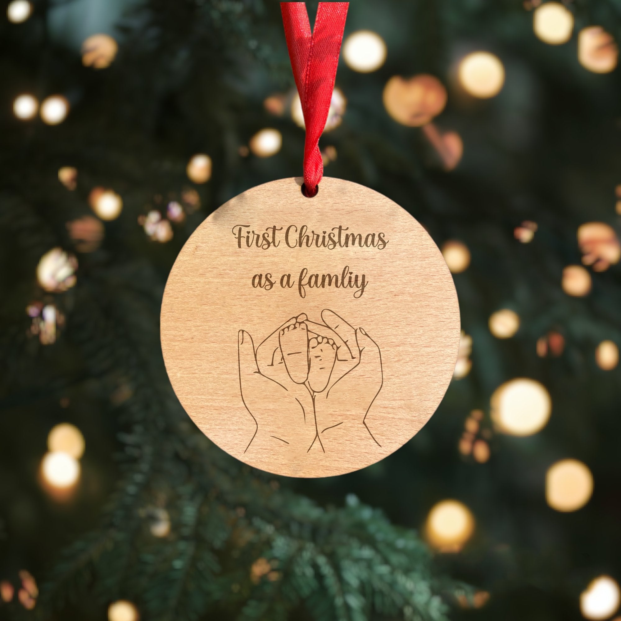 A wooden plaque celebrating "First Christmas As A Family" with a festive design.