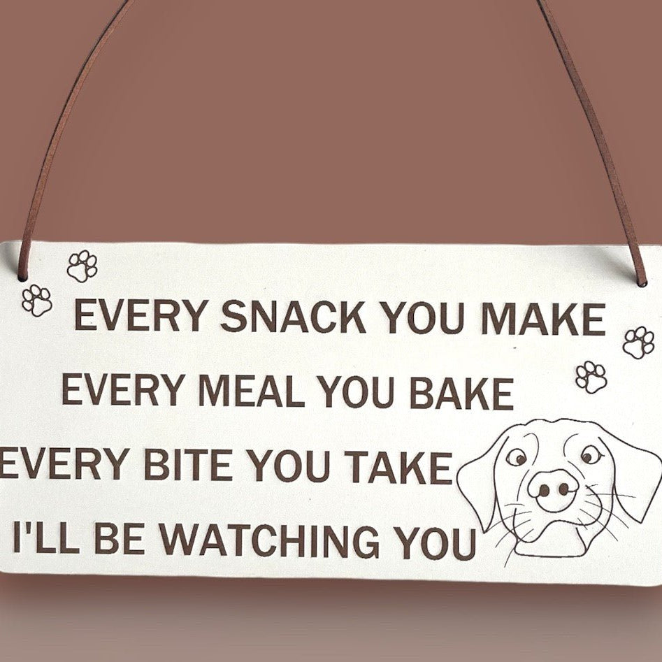 Plaque Size: 220 x 110 mm (approx) Thickness: 3mm Text reads: Every snack you make every meal you bake every bite you take i'll be watching you Suitable For: Dog Signs For Home, Gifts For Dog Lovers, Dog Signs And Plaques, Funny Dog Sign, Birthday Gift Style: Contemporary Material: White coated MDF with brown faux leather hanger Indoor use only Made in England