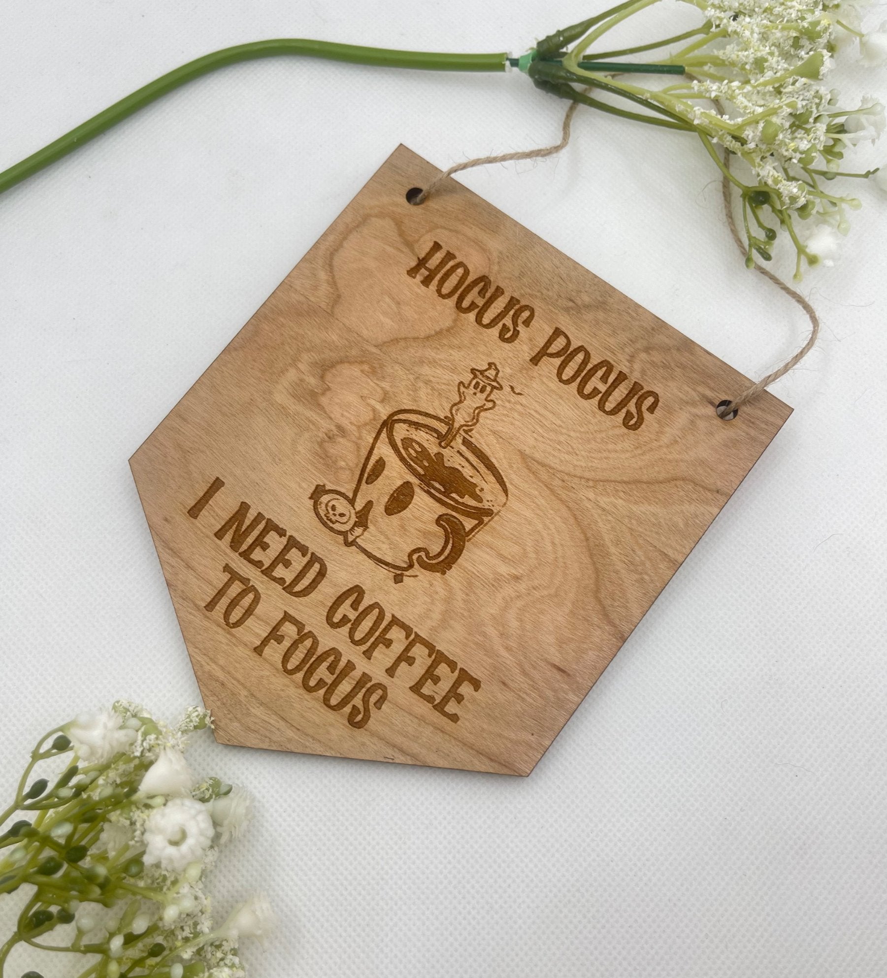 A "Hocus Pocus I Need Coffee to Focus" sign, a humorous piece of Halloween decor.