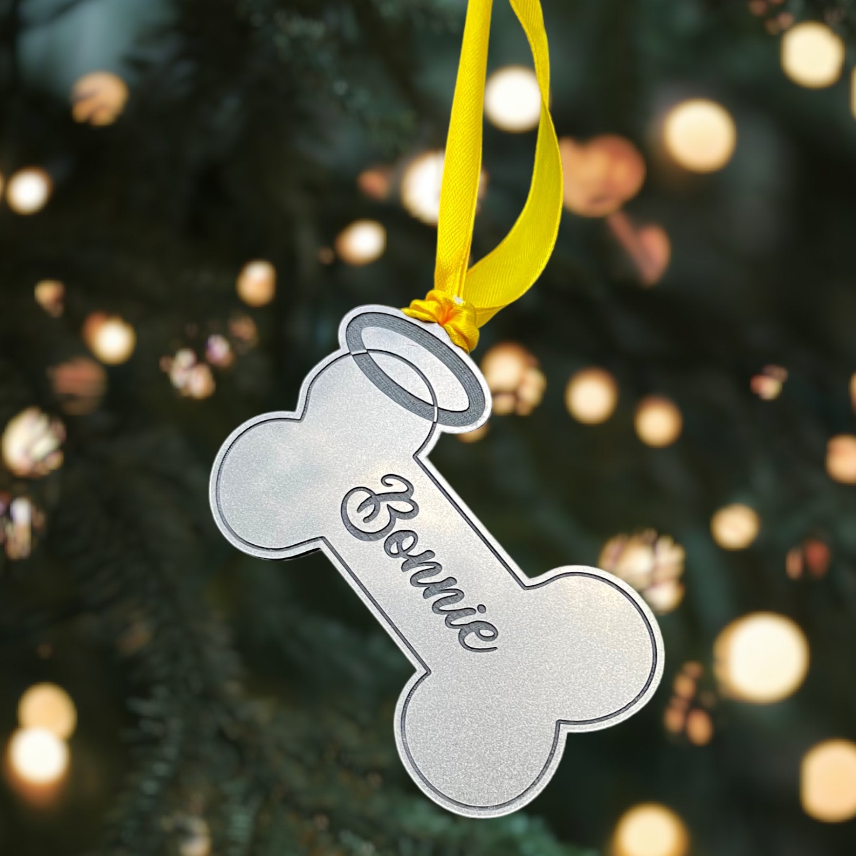A hanging plaque for a dog, with a halo and the engraved name "In Loving Memory of."