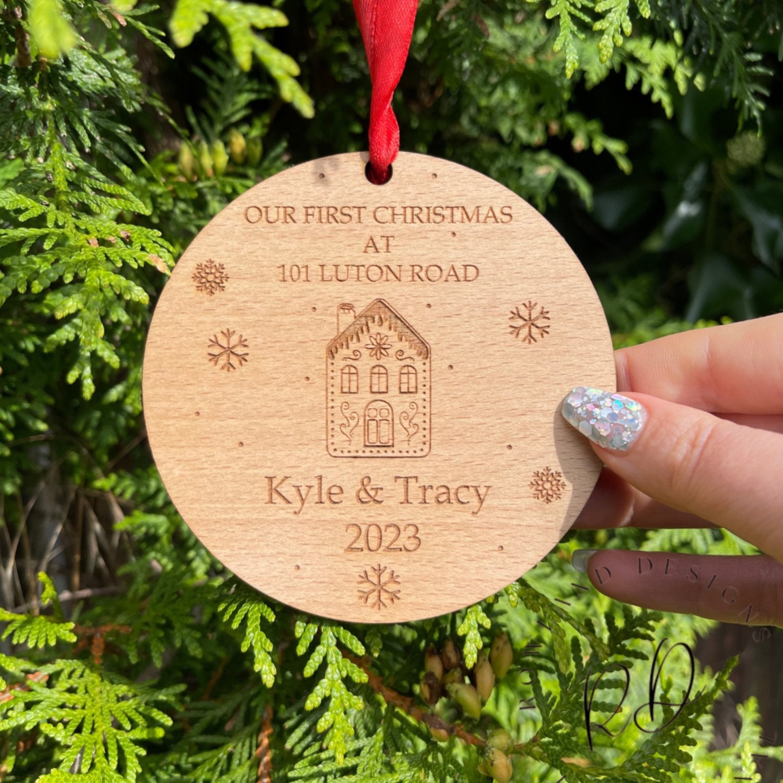 A wooden Christmas keepsake to celebrate a first home, with an engraved design.