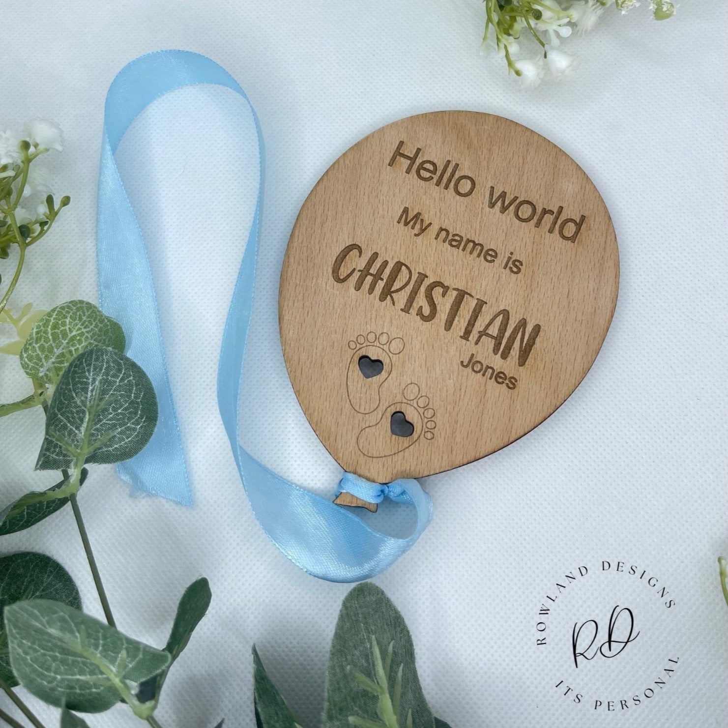 Personalised wooden baby announcement plaque with a balloon and cloud design.