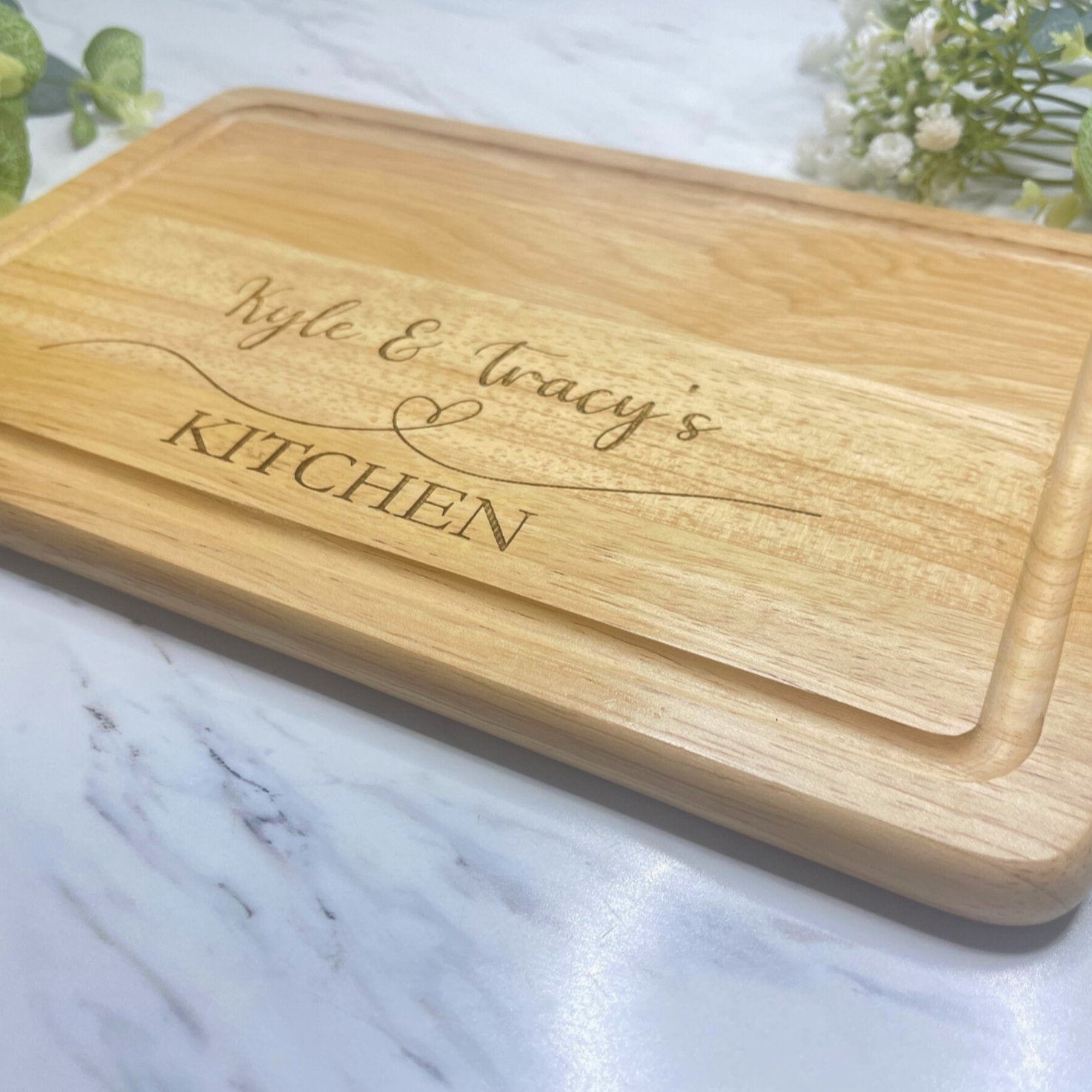 Personalised engraved chopping board on kitchen worktop