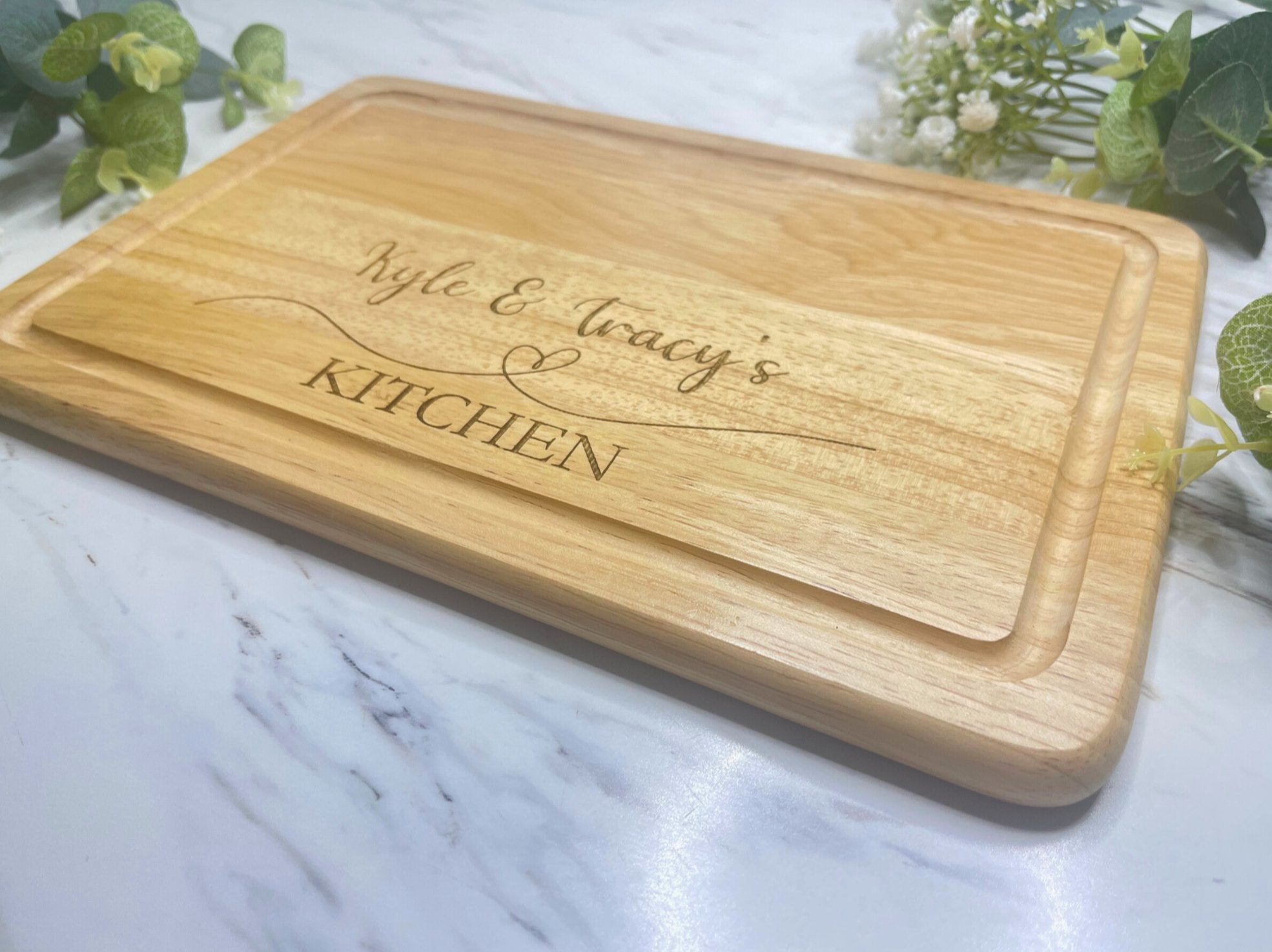 Personalised engraved chopping board on kitchen worktop