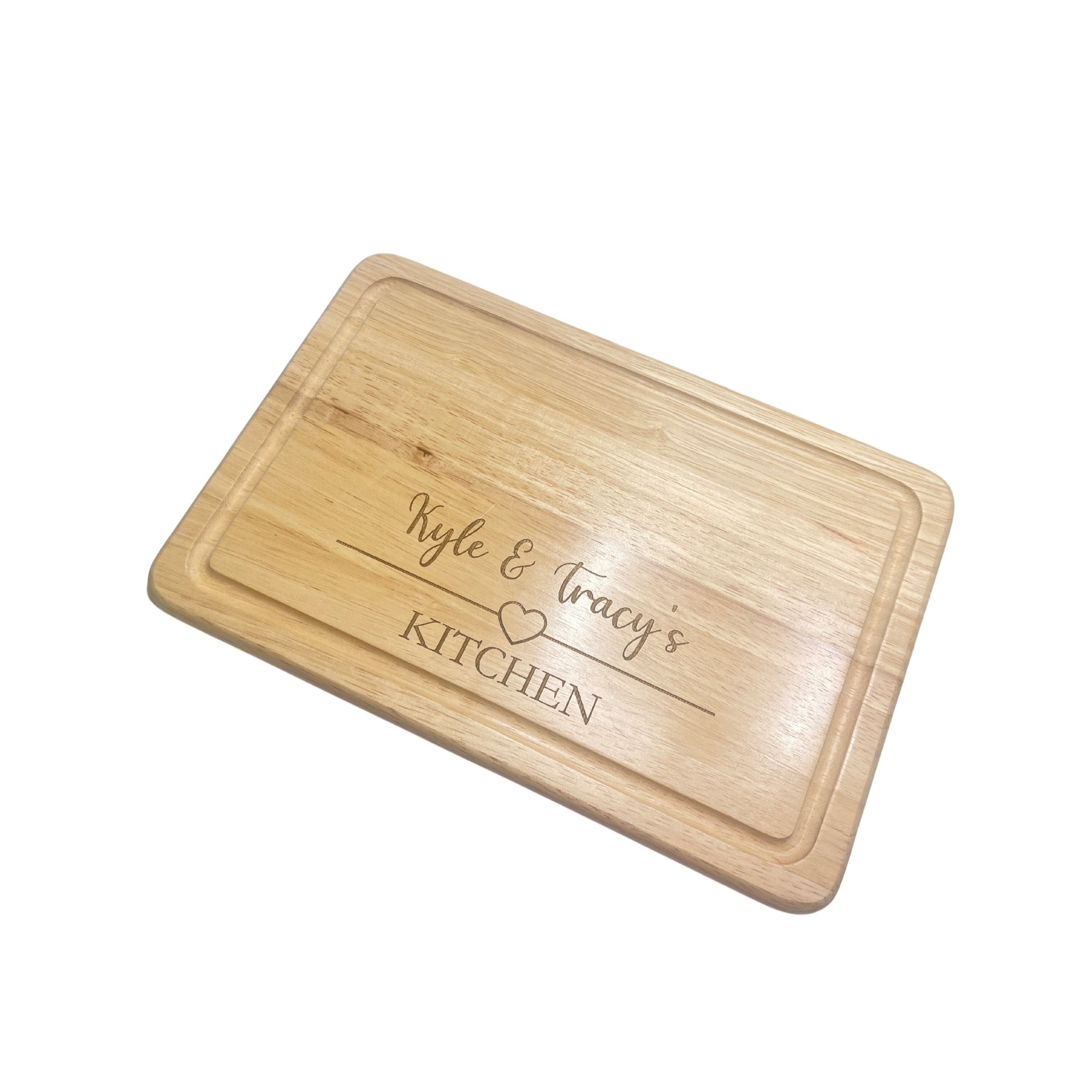 no background - Personalised wooden chopping board with a heart design and custom engraved names.