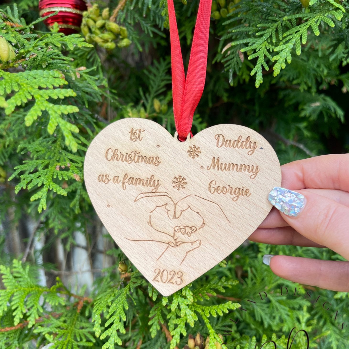 Personalised Wooden Heart Shaped Christmas Bauble with names to celebrate a "First Family Christmas."