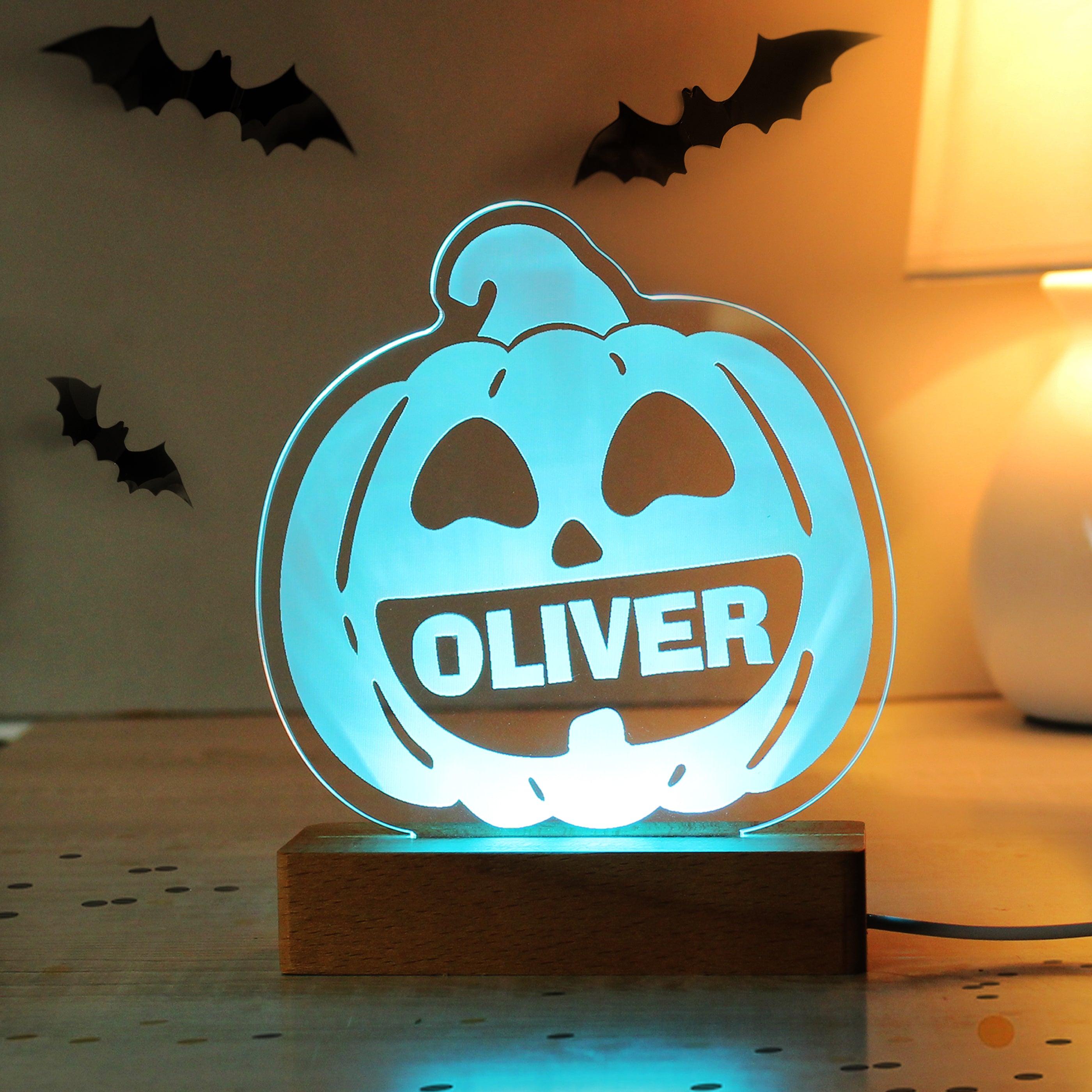 Halloween-themed LED lamp with 'OLIVER' on a wooden base, surrounded by decorative bats.
