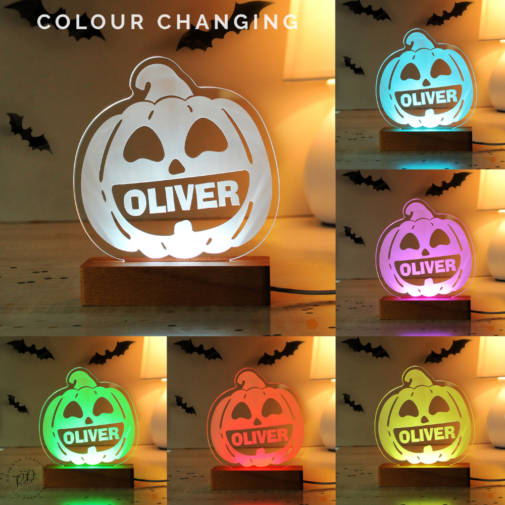 Color-changing pumpkin-shaped night light with 'OLIVER' on a Halloween-themed background.