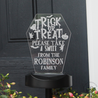 Halloween-themed acrylic sign with 'Trick or Treat' message on a black background