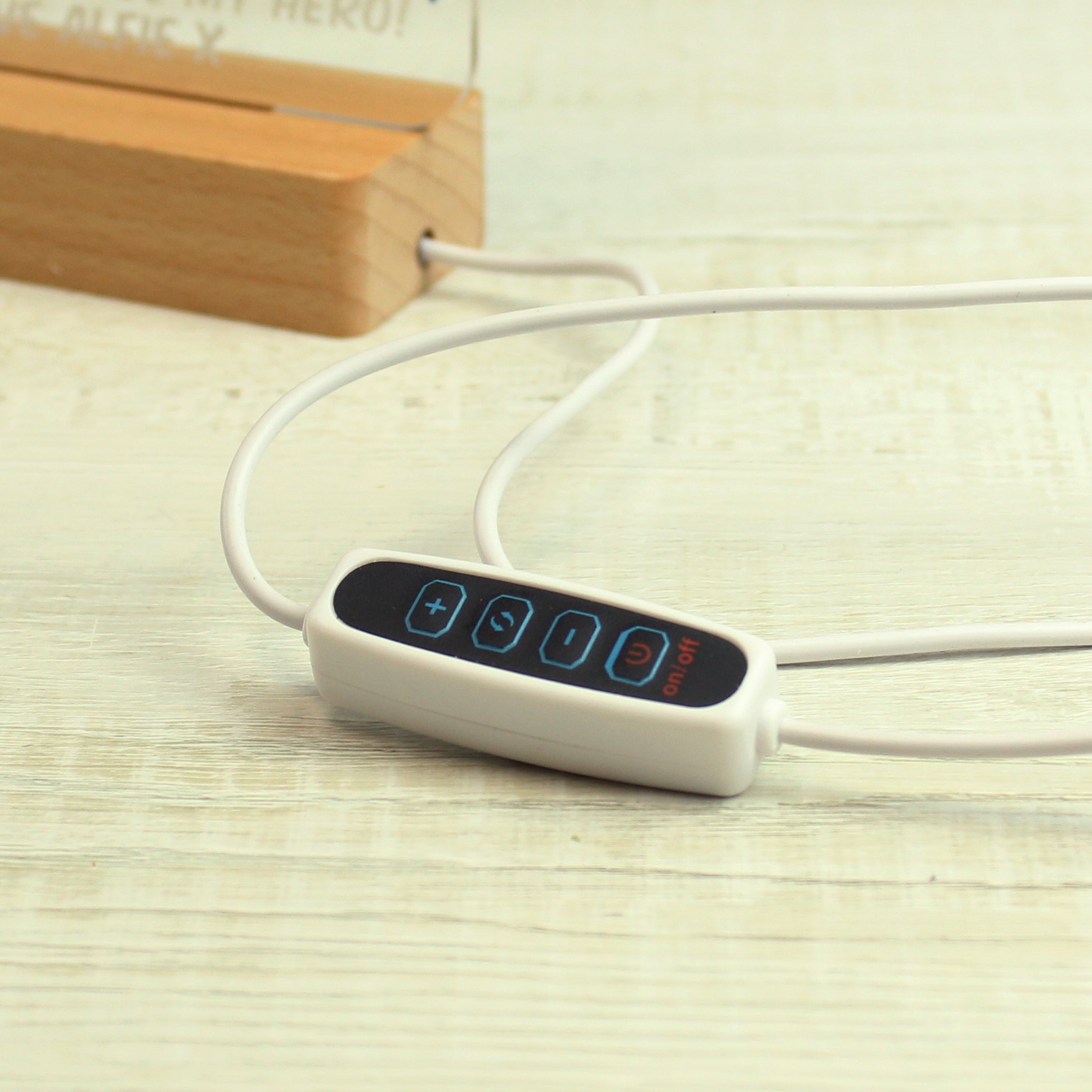 White electronic device with digital display on a light wooden surface