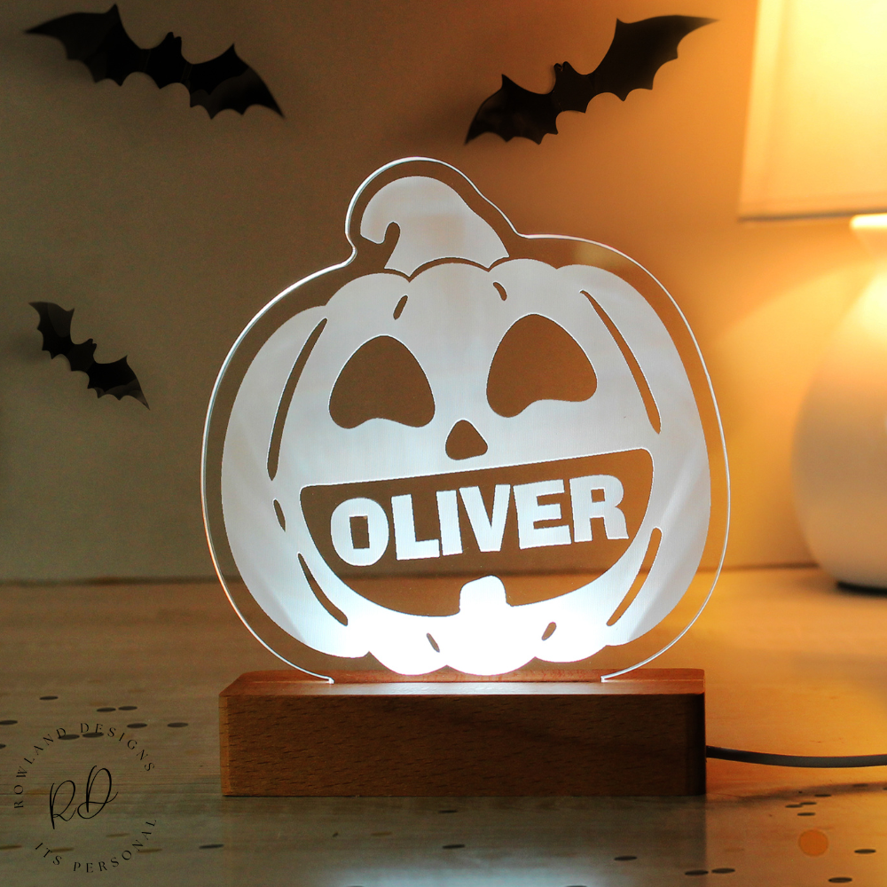 Halloween-themed lamp with 'OLIVER' on a wooden base, surrounded by decorative bats.