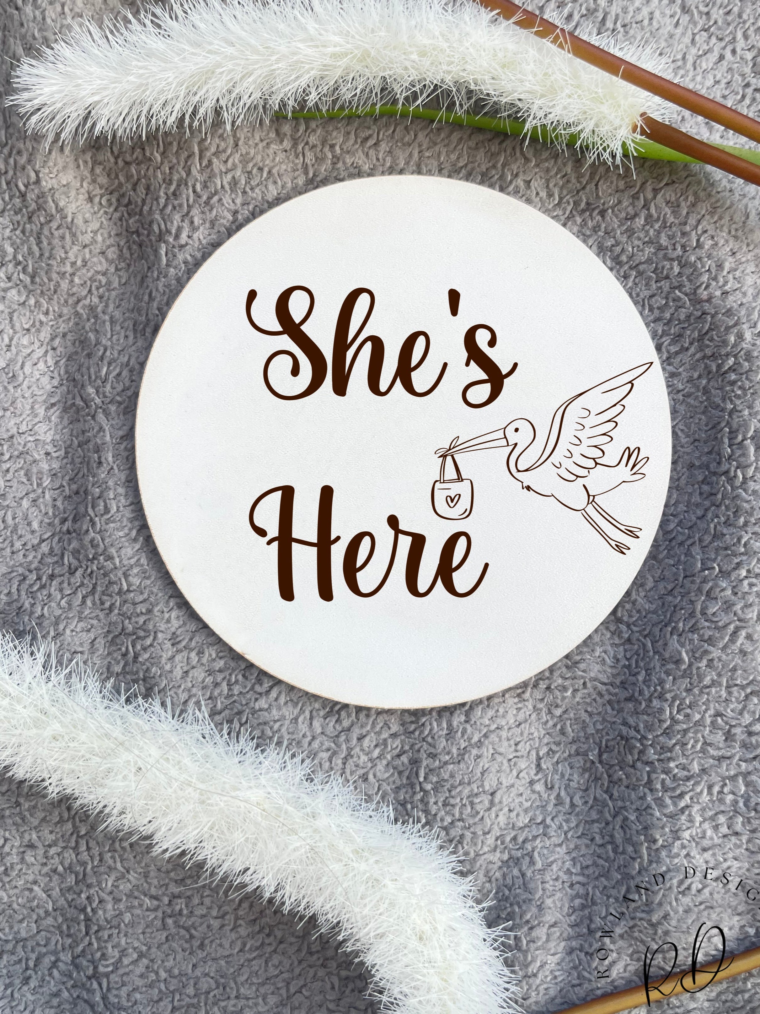 Newborn Welcome Plaque – 'She’s Here' Baby Announcement Plaque, made from durable veneer or MDF, perfect for baby shower gifts and newborn keepsakes.