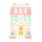 A charming blush pink cottage-shaped ceramic wax warmer and oil burner with a removable roof. Designed for use with fragrance oils or wax melts to create a cozy and fragrant home environment.
