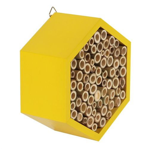 Close-up detail of the bee hotel showing the intricate woodwork and bee-friendly openings.