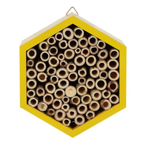 Bee hotel hanging from a tree or fence, ready to attract pollinators.