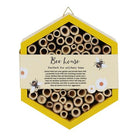 Front view of a wooden bee hotel designed for attracting solitary bees.