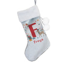 Personalised Christmas stocking hung on a mantelpiece, ready for Santa.
