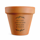 Terracotta pot with engraved message on a white background