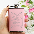 Close-up of personalised name engraving on pink hip flask.