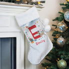 Close-up of custom printed name and initial on the velvet Christmas stocking.
