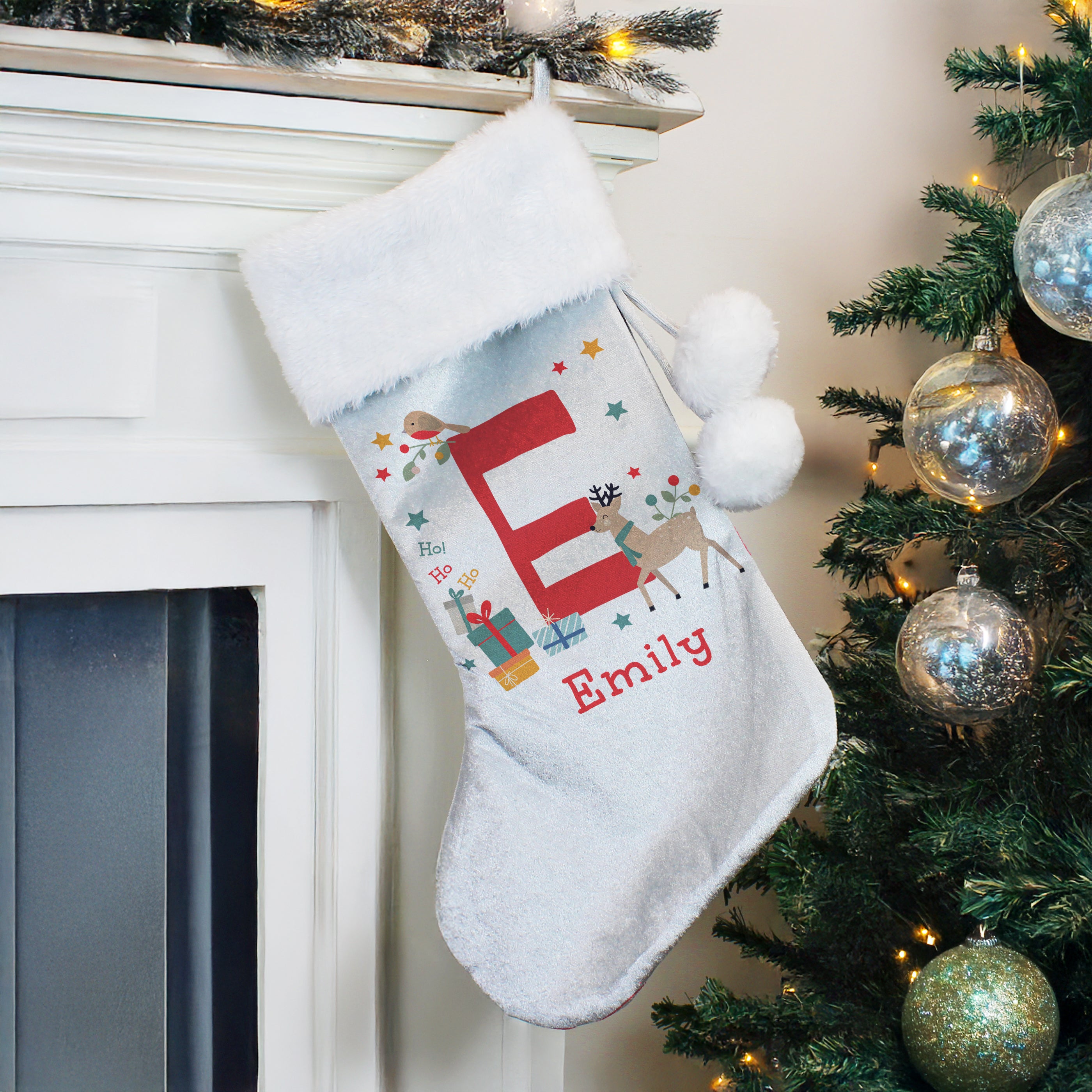 Close-up of custom printed name and initial on the velvet Christmas stocking.
