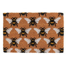 Eco-friendly coir doormat with a cute bee print, perfect for indoor use.