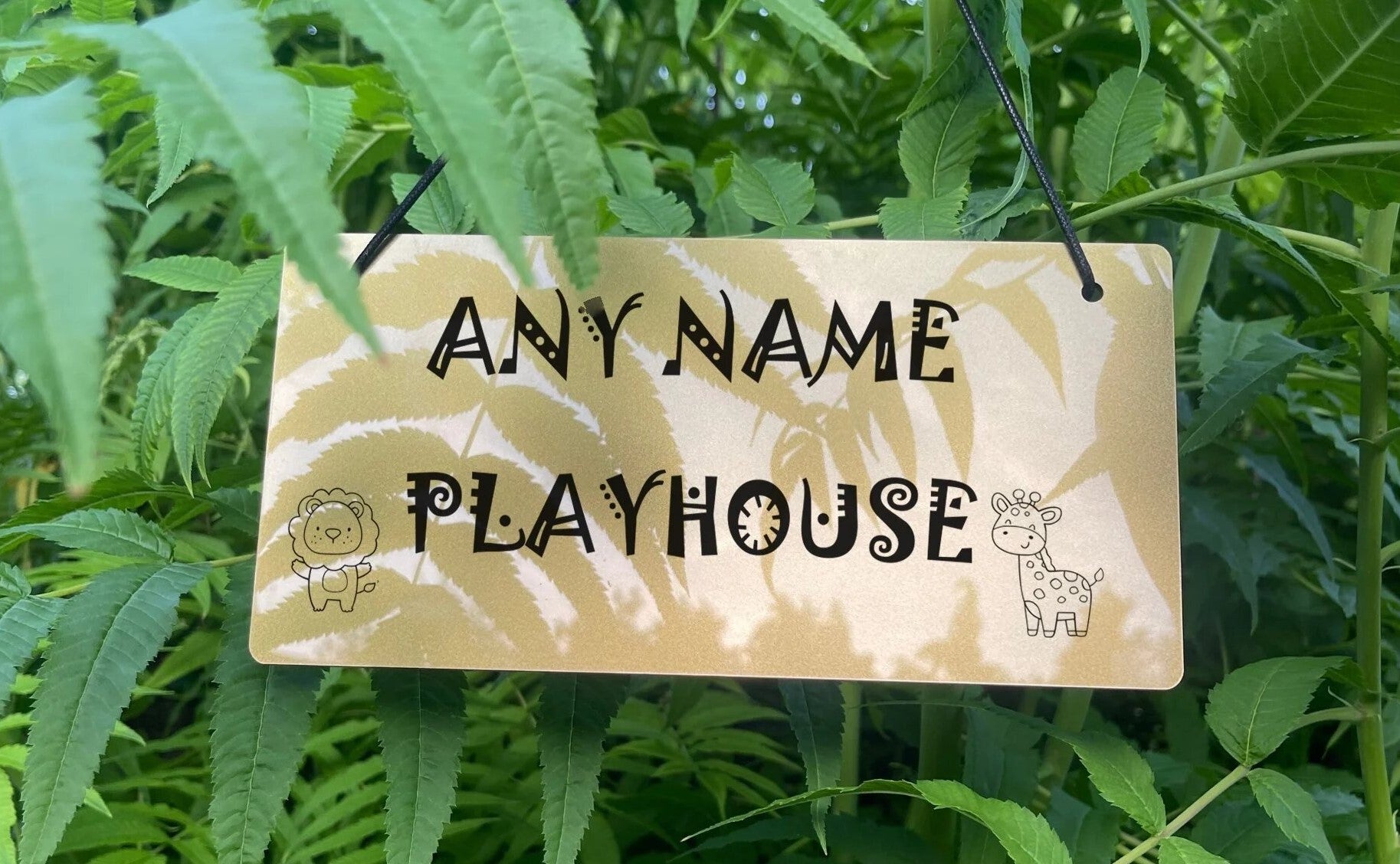 The engraved acrylic sign for a child's playroom, featuring a cute lion and giraffe design with a personalized name.