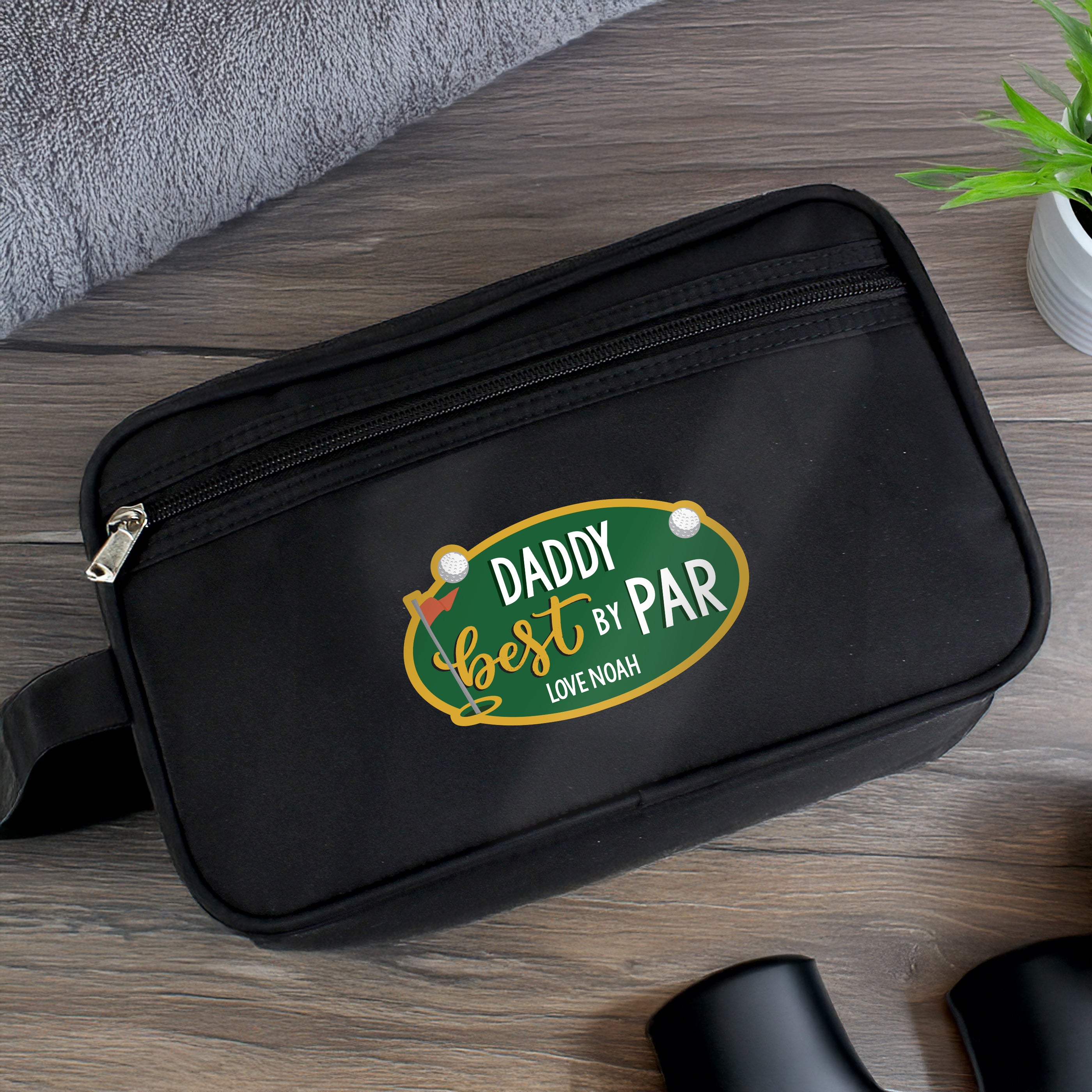 Black personalised Best By Par wash bag with custom name and golf themed design