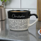 Black and white mug with 'Christopher' on a kitchen counter